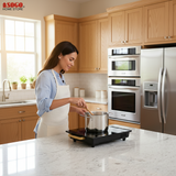 Black induction cooktop with gold accents on a white background, featuring the SOGO brand.